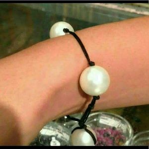 Large MOP freshwater pearls on a black cord “